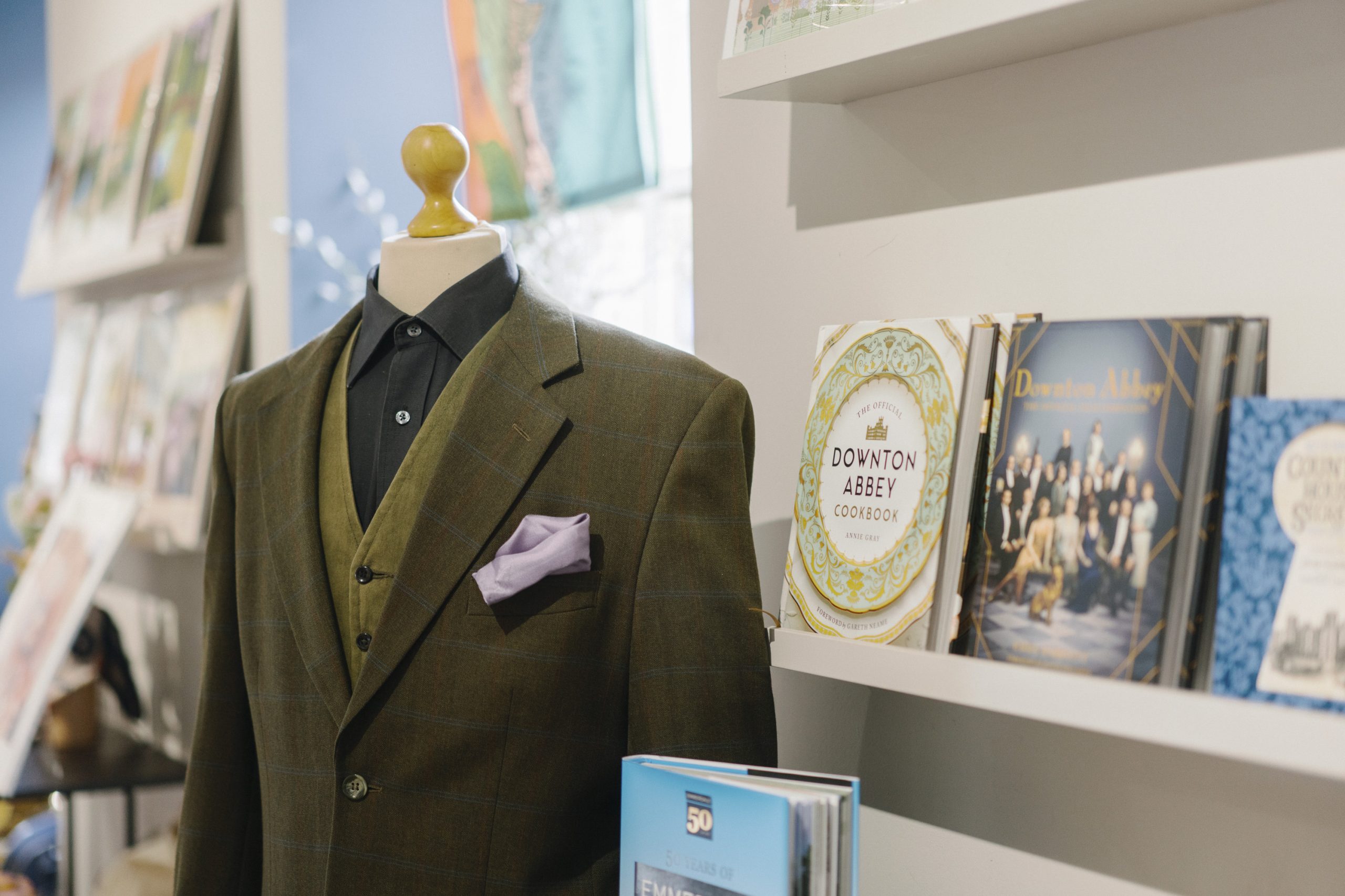 Zak Dingle's authentic costume, worn by the late actor Steve Halliwell during his role on the British soap opera Emmerdale, displayed alongside official memorabilia from Downton Abbey and Emmerdale in the Courtyard Shop.