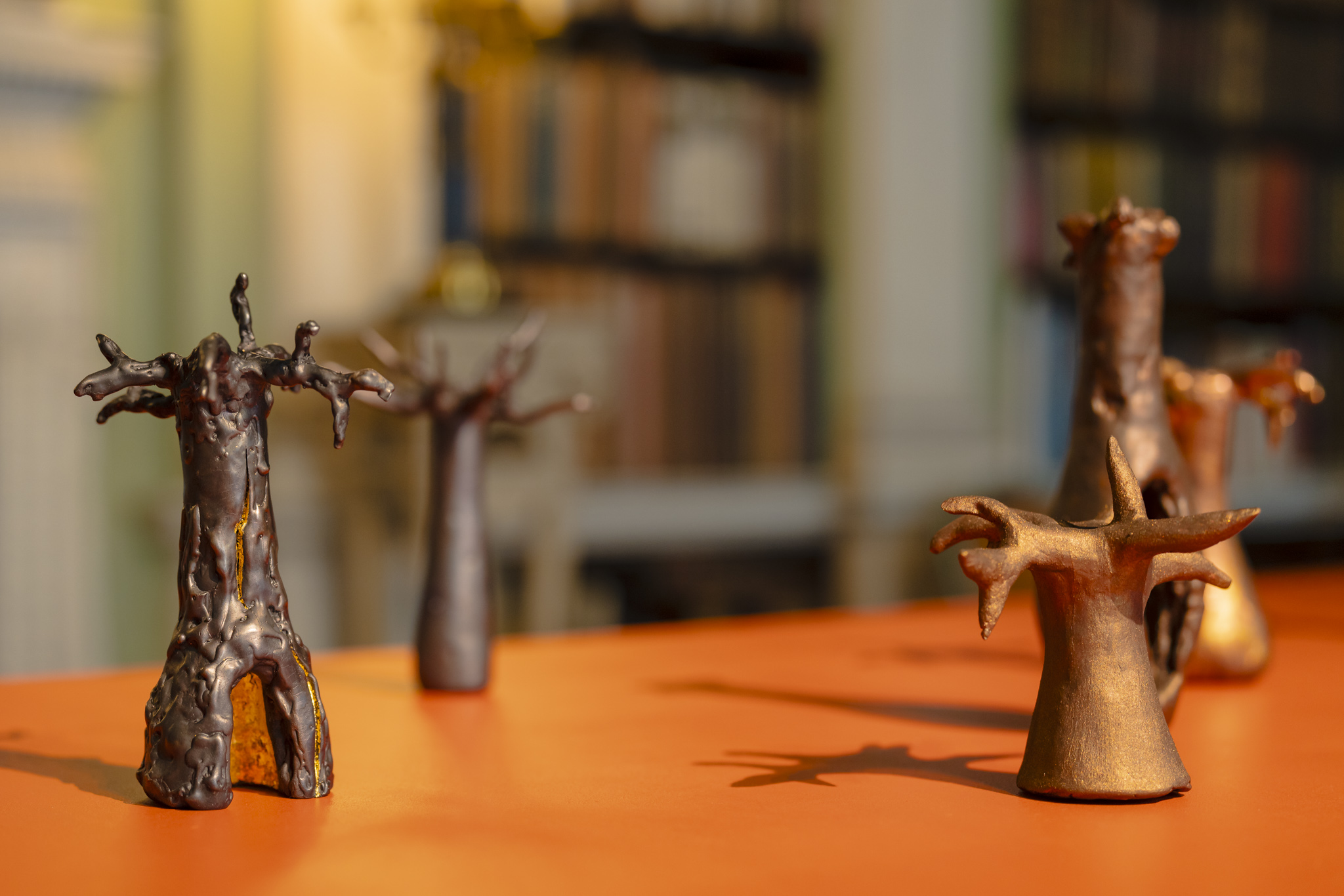 Five miniature hand cast bronze Baobab trees stand proudly on a desk in the Old Library at Harewood.