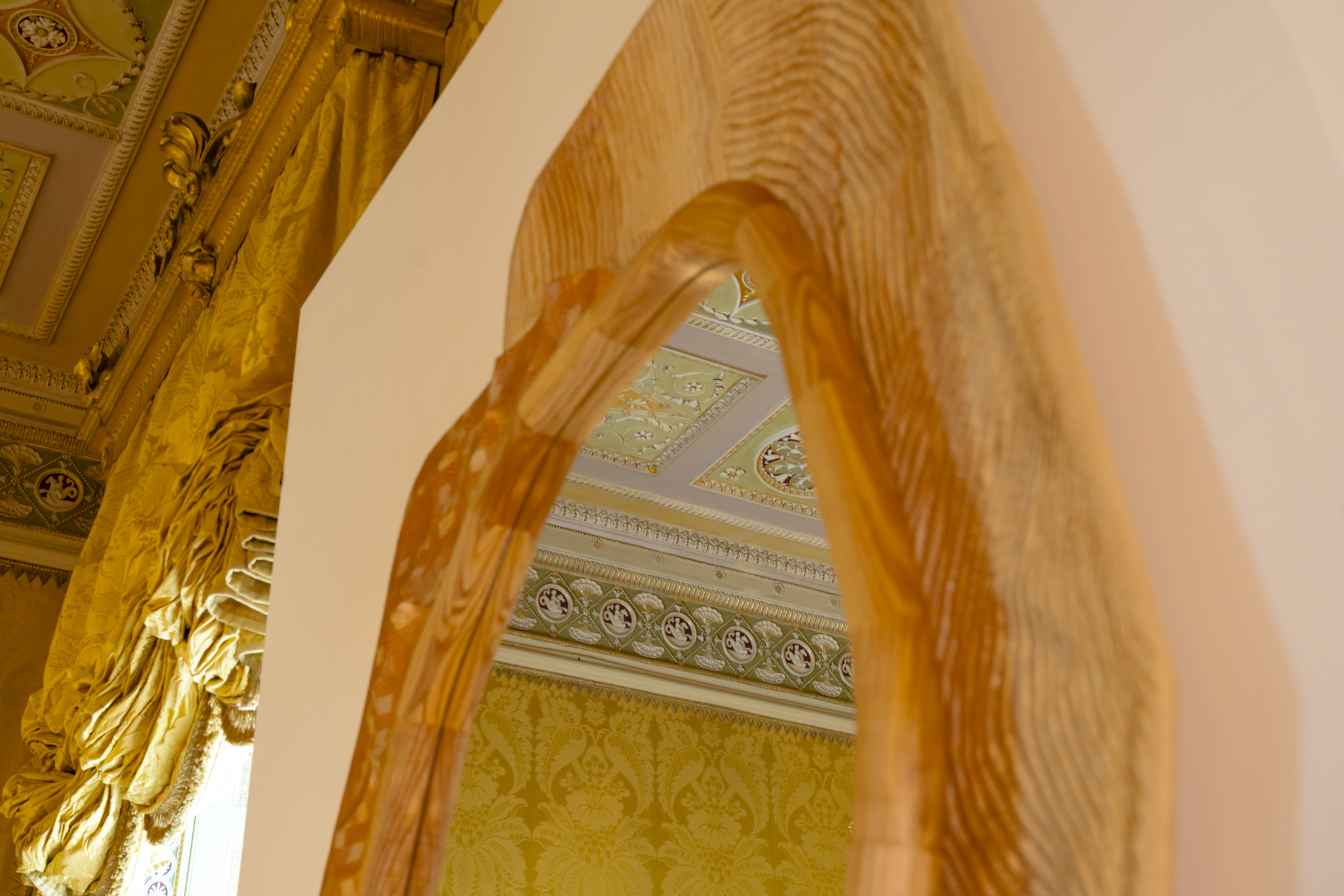 Delicate, three-dimensional patterns carved into the ceiling of the Yellow Drawing Room are reflected in a wooden mirror. The patterns combine geometry, nature, and art into one harmonious whole.