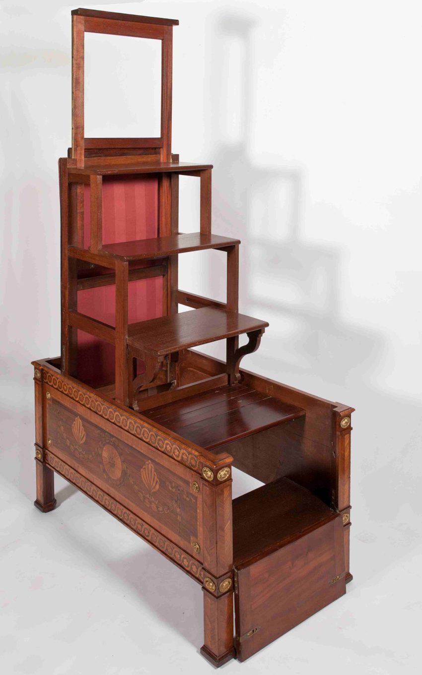 A set of mahogany library steps that fold down into a rectangular case decorated with marquetry.